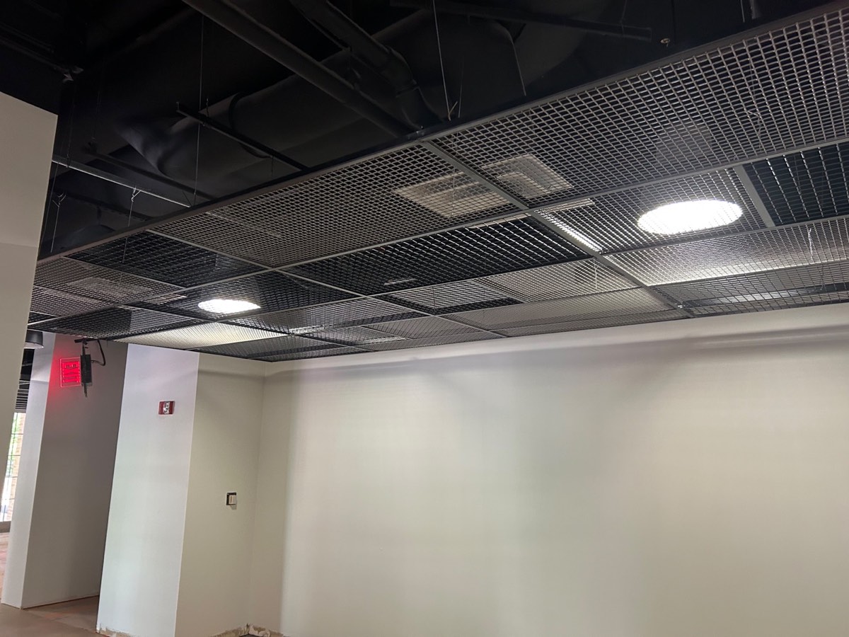 Suspended black metal grid ceiling installed over a commercial space in Austin, TX