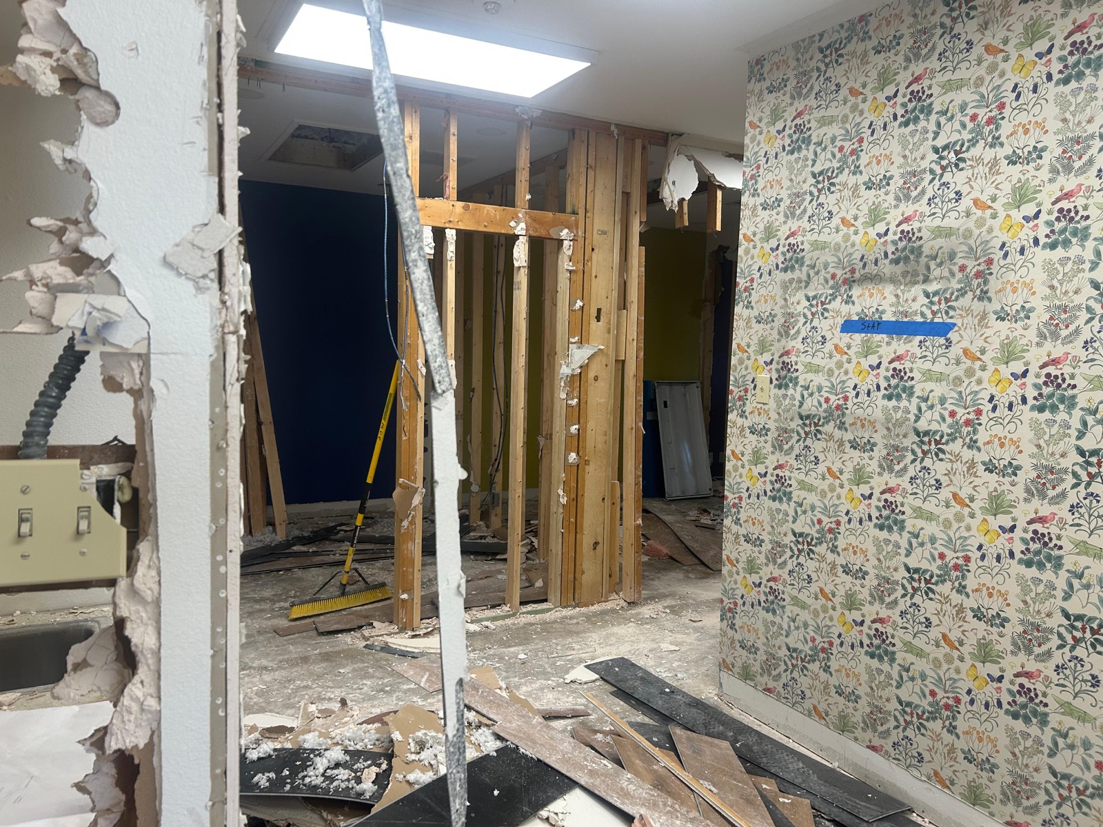 Selective interior demolition with the wall framing exposed and finishes marked to stay on an Austin project by Martinez Professional Construction