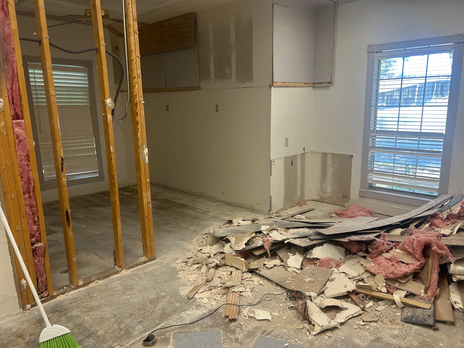 Interior demolition tear-out with drywall and insulation stripped back to the framing on an Austin job by Martinez Professional Construction