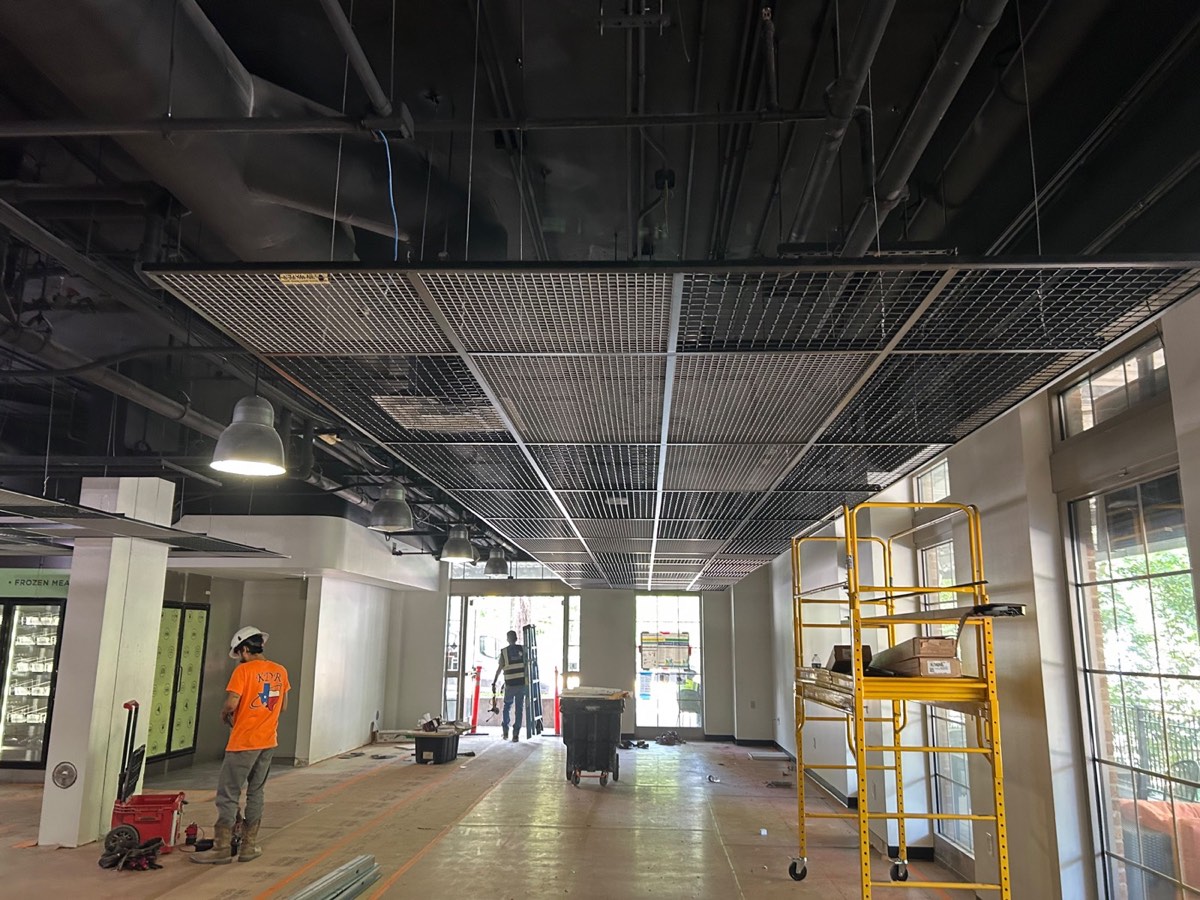 Metal grid ceiling installation on a retail buildout in Austin, TX